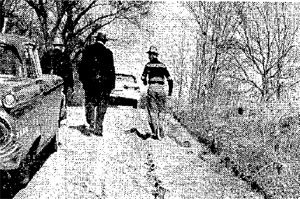 Investigator and White walking away from the grisley discovery (from ...